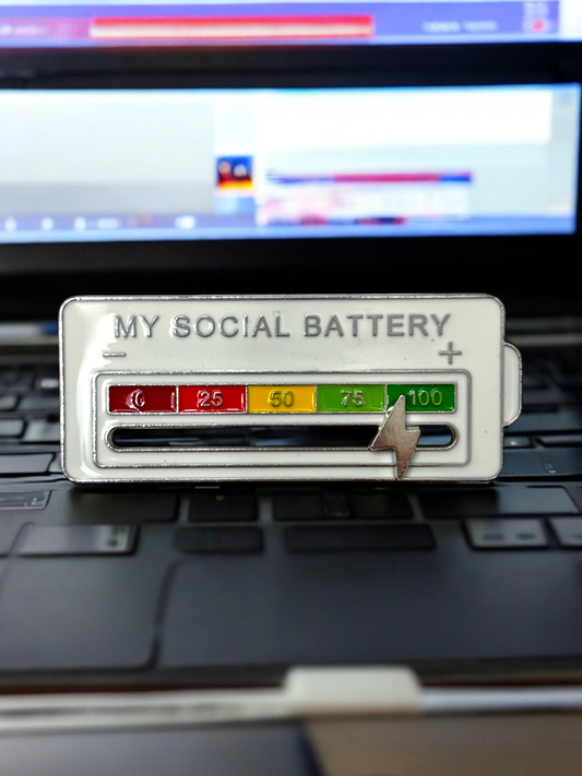 My Social Battery brooch in white with numbers and a white lightning bolt